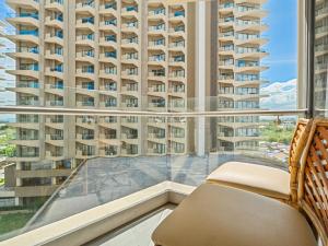 a balcony with a view of a large building at Relaxing 1-Bedroom Resort Condo Unit at Tambuli Seaside Living, Mactan, Lapu-lapu City in Maribago