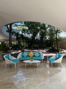a group of chairs and tables in a building at Relaxing 1-Bedroom Resort Condo Unit at Tambuli Seaside Living, Mactan, Lapu-lapu City in Maribago