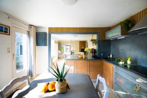 a kitchen with a table with fruit on it at Côte et Mer in Wissant +16 photos