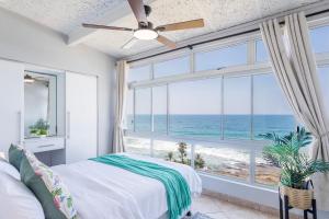 a bedroom with a bed and a large window with the ocean at Sea View Luxury Penthouse in Ballito