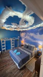 a bedroom with a bed with a painting of clouds at Le Good Vibes in Dieppe