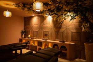 a living room with a couch and a table with lights at La Bastide des Rameaux - Boutique Hôtel & Spa in Callas