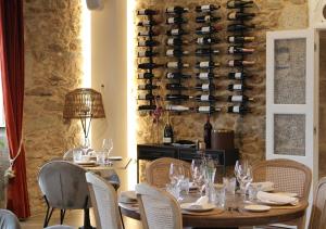 a dining room with a table and chairs and a wine cellar at Hospedium Hotel Barómetro de Camariñas in Camariñas