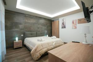 a bedroom with a large bed and a wooden floor at Xenia in Crotone