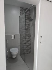 a bathroom with a toilet and a glass shower at Oloisiri Namanga Hotel in Namanga +26 photos