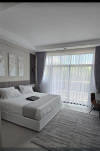 a bedroom with a large bed and a large window at Oloisiri Namanga Hotel in Namanga