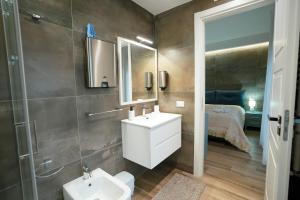 a bathroom with a sink and a mirror at Xenia in Crotone +76 photos