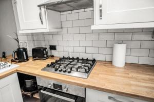 a kitchen with a stove top on a counter at Central Manchester Family-Friendly Home with Free Parking and Workspace in Manchester