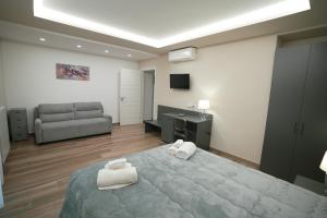 a bedroom with a large bed and a couch at Xenia in Crotone
