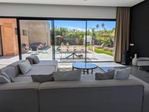 a living room with two couches and a patio at Villa LaLa in Marrakesh