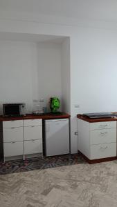 a kitchen with white cabinets and a counter top at Casa dell'Aloe in Angri