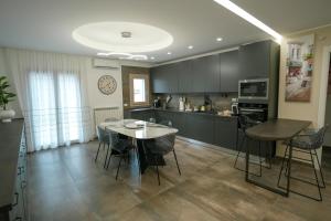 a kitchen and dining room with a table and chairs at Xenia in Crotone