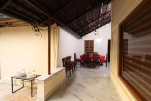a dining room with a table and chairs at Vayuvana Heritage Organic Farm Resort in Panamaram