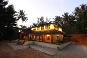 a small house with lights on top of it at Vayuvana Heritage Organic Farm Resort in Panamaram