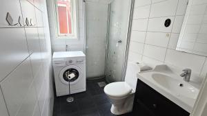 a bathroom with a toilet and a washing machine at Two cozy accommodations near the sea SE09118 in Gåseknöde +21 photos