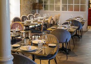 a row of tables and chairs in a restaurant at Hospedium Hotel Barómetro de Camariñas in Camariñas +68 photos