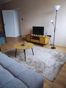 a living room with a couch and a coffee table at Lilibella apartman in Miskolc