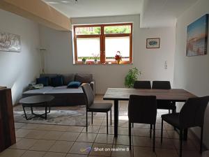 a living room with a table and a couch at Ferienwohnung Klaus in Warngau