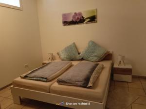 a bed with two pillows on it in a room at Ferienwohnung Klaus in Warngau