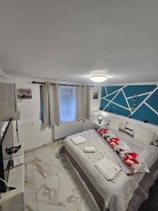 a bedroom with a large bed with flowers on it at Studio Superior Iris in Baile Felix