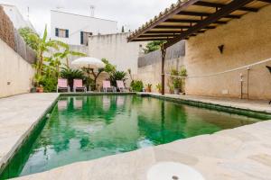 a swimming pool in the courtyard of a building at Calvario Townhouse by rentavillamallorca in Pollença