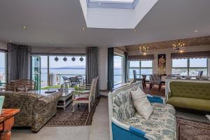 a living room with a view of the ocean at 43 Artemis, Langebaan, 8-sleeper in Langebaan