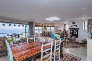 a dining room and living room with a table and chairs at 43 Artemis, Langebaan, 8-sleeper in Langebaan