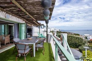 a patio with a table and chairs and the ocean at 43 Artemis, Langebaan, 8-sleeper in Langebaan