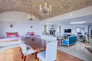 a dining room and living room with a table and chairs at 43 Artemis, Langebaan, 8-sleeper in Langebaan +37 photos