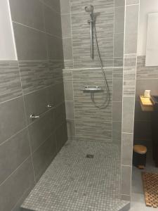 a bathroom with a shower with a tiled floor at Don Quichotte in Vallet +50 photos