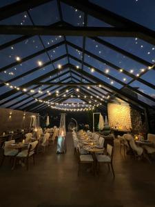 a restaurant with white tables and chairs and lights at Pousada Villa Monte Verde in Monte Verde +93 photos