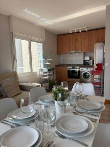a dining room table with white plates and wine glasses at Mundaka Best Views House in Mundaka +11 photos