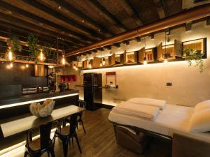 a large room with a bed and a kitchen at La Vite Apartments by Queen Gallery in Desenzano del Garda