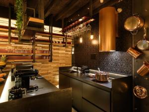 a kitchen with a stove and a counter top at La Vite Apartments by Queen Gallery in Desenzano del Garda +21 photos