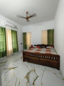 a bedroom with a bed with a cracked floor at The Haira Varkala in Varkala
