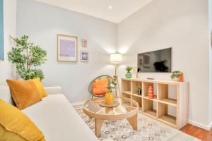 a living room with a couch and a table at Heimby - Studio w Free parking in Bergen