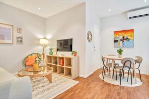 a living room with a table and chairs and a couch at Heimby - Studio w Free parking in Bergen