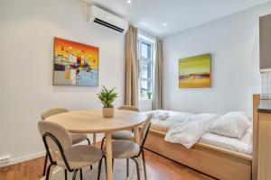 a bedroom with a bed and a table and chairs at Heimby - Studio w Free parking in Bergen