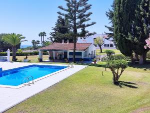 a villa with a swimming pool and a house at 06 Sra da Rocha - Casas & Papeis in Porches