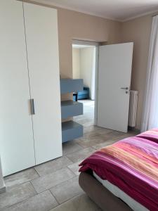 a bedroom with a bed and a sliding glass door at Villa dei Roveri in Tignale