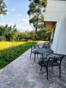 a patio with a table and chairs on a patio at Volterra Guatavita in Guatavita