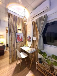 a room with a table and a mirror on a wall at PBrooms in Mui Ne