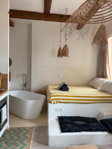 a bathroom with a tub and a bed and a bath tub at LaFrenchCasa Canebière in Marseille