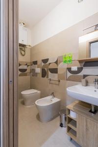 a bathroom with two sinks and a toilet at Al numero 1 - Guest House in Nova Siri Marina +13 photos