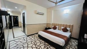 a bedroom with a large bed in a room at Aadhar Hotel in Gurgaon