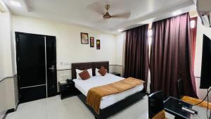 a hotel room with a bed and a window at Aadhar Hotel in Gurgaon