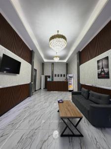 a living room with a couch and a table at Emirate Plaza in Sergeli