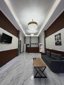 a living room with a couch and a table at Emirate Plaza in Sergeli