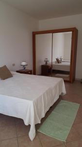 En eller flere senge i et værelse på Casa Vacanze Capoterra
