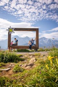 a group of people sitting on a bench with a mirror at Hotel Schynige Platte in Wilderswil